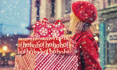 woman-carrying-three-present-boxes