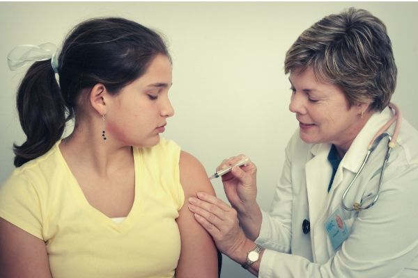 woman-injecting-girl-s-left-arm