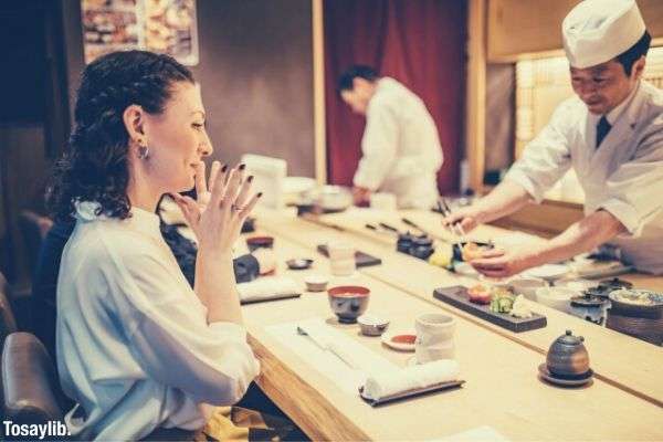 woman sitting looking at the sushi