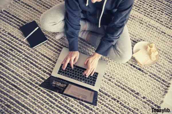 photo of woman using laptop carpet snacks