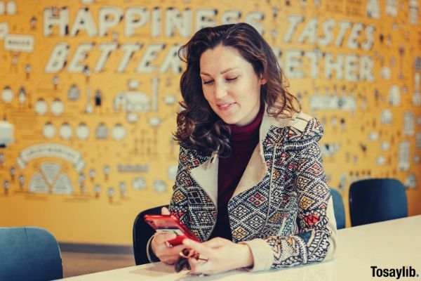 woman jacket using red phone table