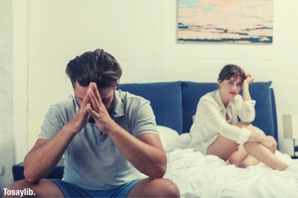 01 man and woman mad sitting on the bed woman looking on the guy