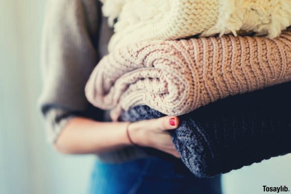 04 person holding hand knitted clothes