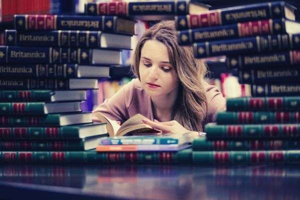 girl-in-pink-long-sleeves-reading-book
