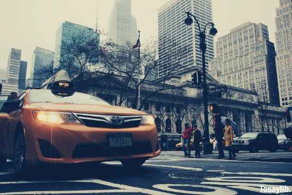 yellow toyota sedan taxi on highway road