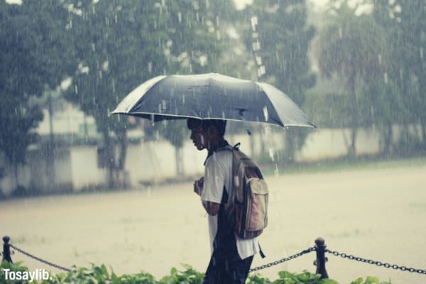 rainy days teen holding umbrella raining