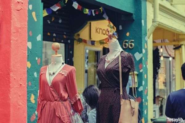 people standing behind the maniquin dress model outdoor