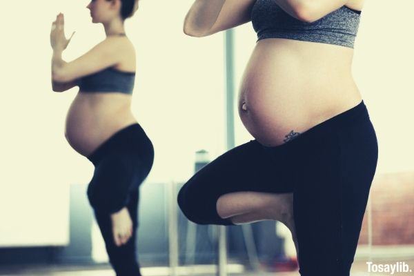 pregnant woman doing yoga belly button