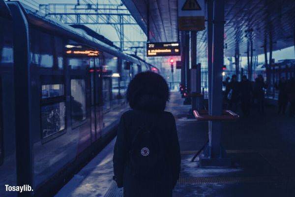 dim person standing wearing sweater train