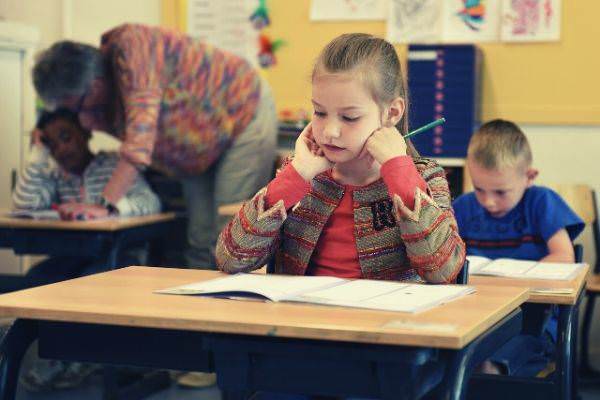 children-having-their-exam-girl-holding-pencil-answering-test-paper