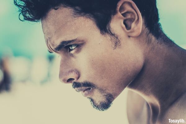 Photo of a man s face sweating a lot on the beach