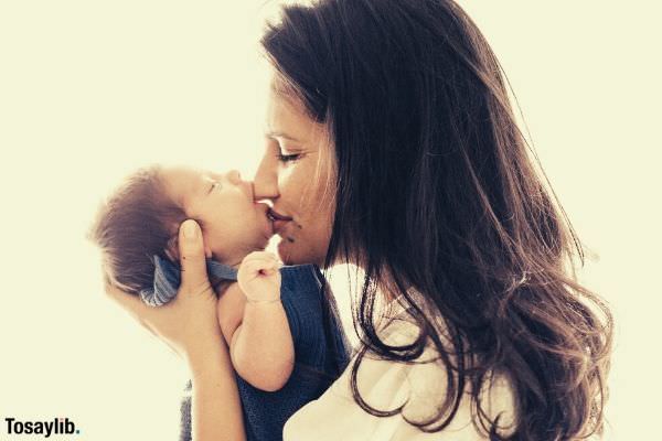 woman kissing the baby