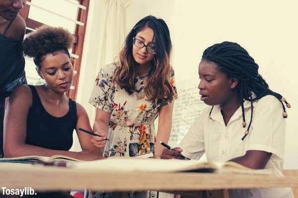 women at the meeting three black girls and one with glasses