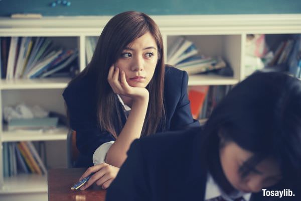 japanese student thinking wearing black blazer