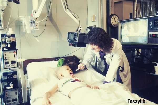 doctor woman checking up a child lying on bed