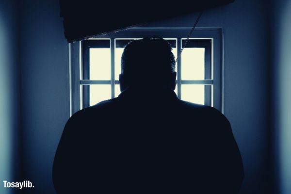 silhouette of a man in window