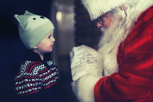 santa-claus-giving-gift-to-a-toddler-wearing-black-sweater