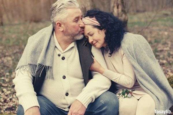 happy senior couple hugging each other at the park