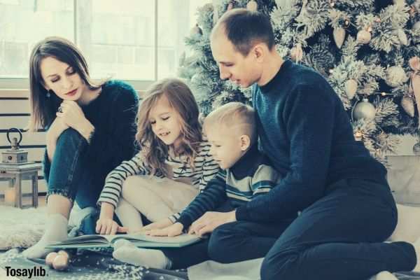 03 family beside christmas tree reading book