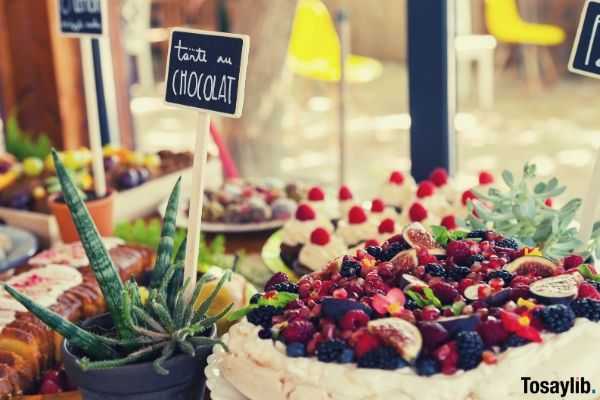 dessert table packed with fruity sweets berries cake cupcakes