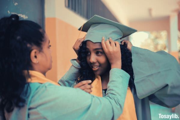 Selective focus woman wearing gray academic gown graduation happy