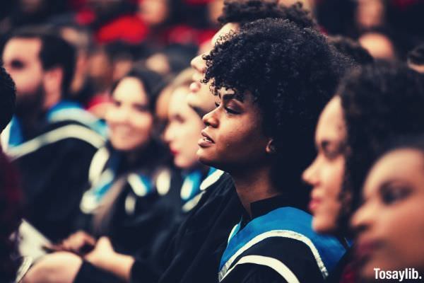 group of people at their graduation rites woman focus curly hair