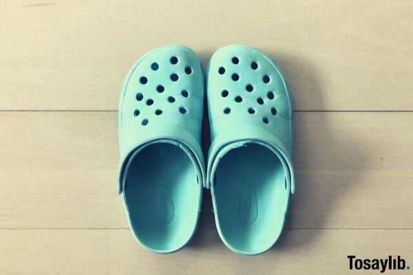 blue crocs like sandals on tile floor