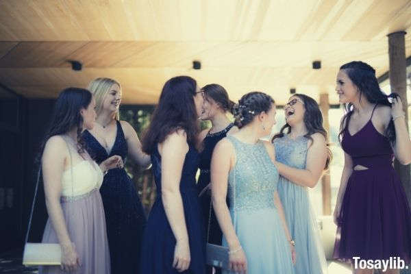 women standing talking and laughing together in homecoming party