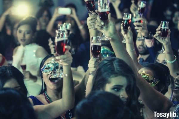 group of women raising champagne flutes mask