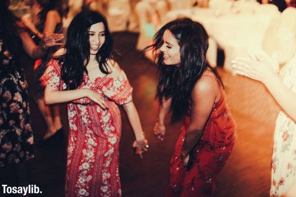 two women in red dress on homecoming dance happy lively