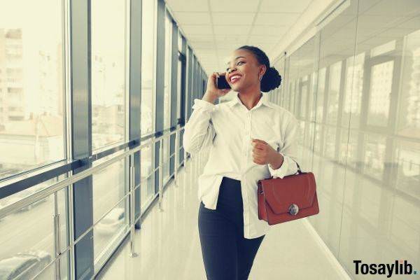 cheerful woman happy friday mood talking on smartphone in the office