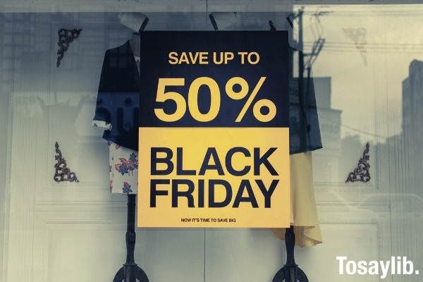 save up to 50 percent black friday sale signage on the glass panel