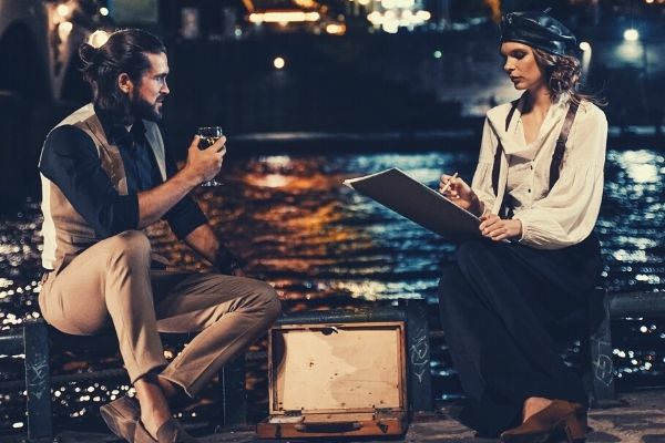 man-and-woman-respond-to-pick-up-line-sitting-on-brown-wooden-dock-during-night-time-eiffel-tower