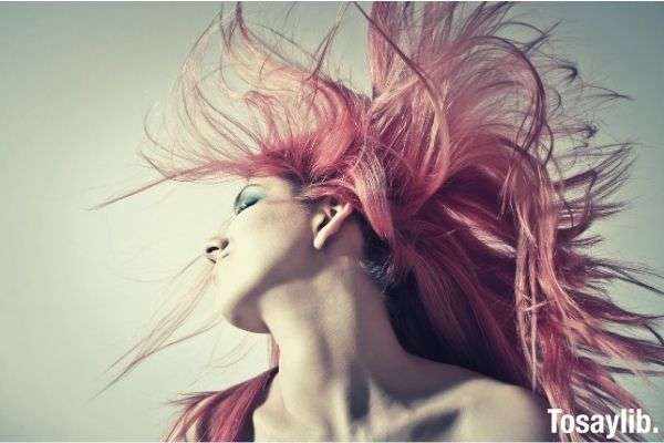 woman waving her red hair photo gray background