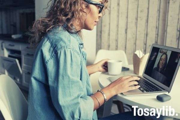 woman in blue denim jacket using macbook pro talking with someone