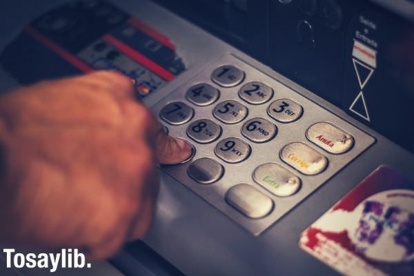 person pressing on the atm keys