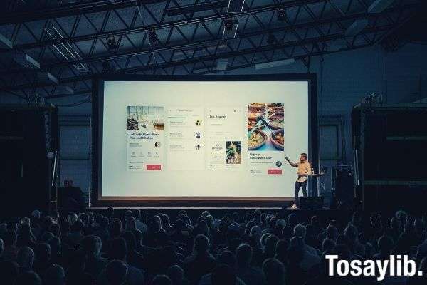 man person discussing presentation while standing in front of big screen