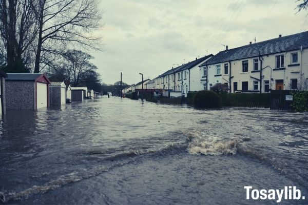 brown concrete building houses flood water during daytime