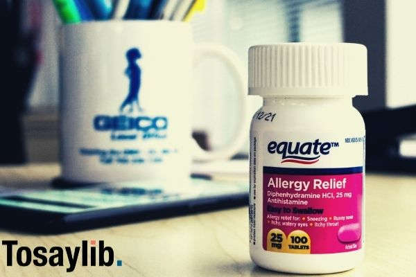 equate allergy relief tablet bottle on wooden table with smartphone