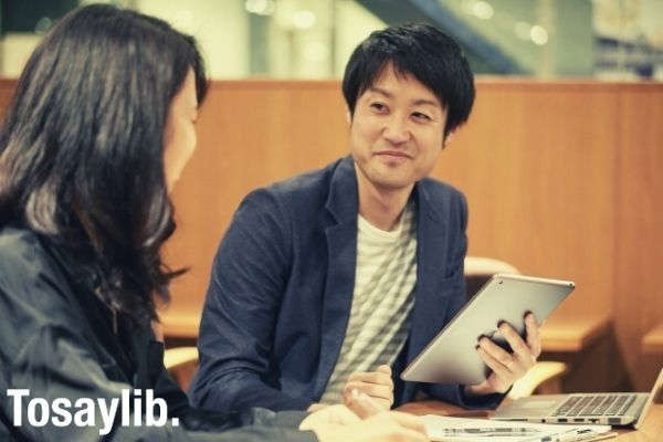 man and woman talking inside office