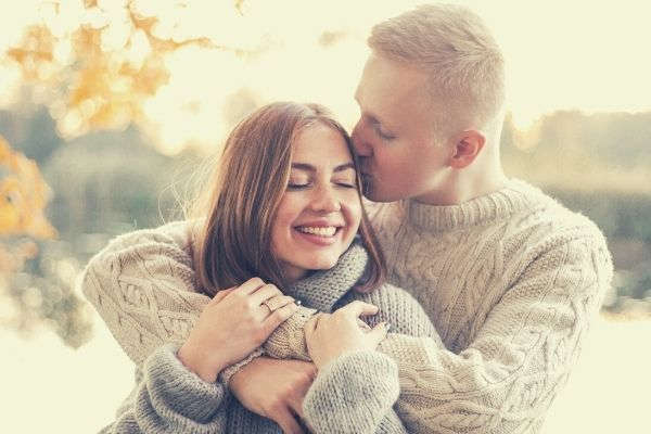 man-in-sweater-kissing-forehead-of-woman-ways-to-say-beautiful