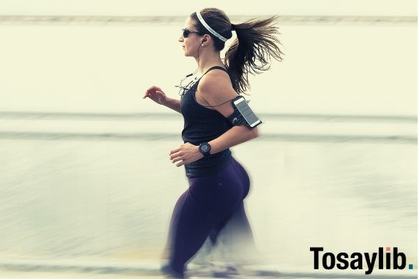 woman in black sleeveless running wearing armband