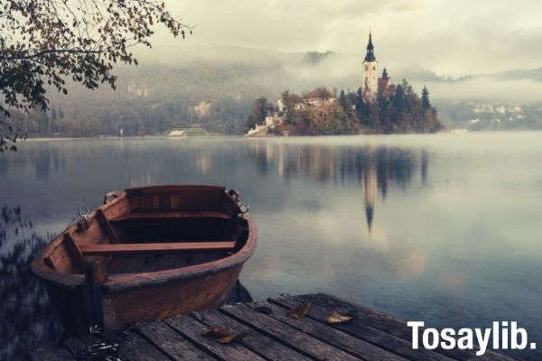 brown wooden boat floating on water