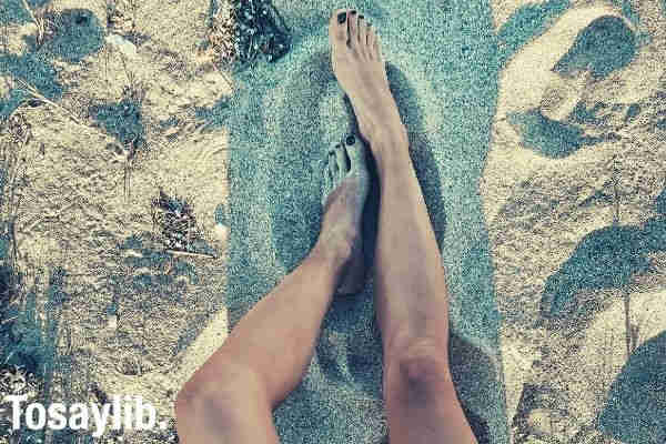 woman wearing black underwear sitting on brown sand