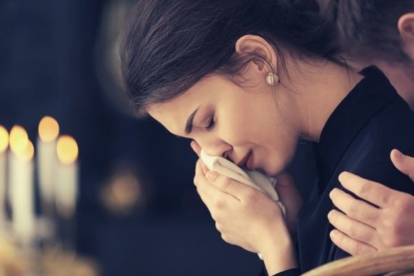 what-to-say-when-you-cannot-attend-funeral-young-woman-crying-wiping-her-tears