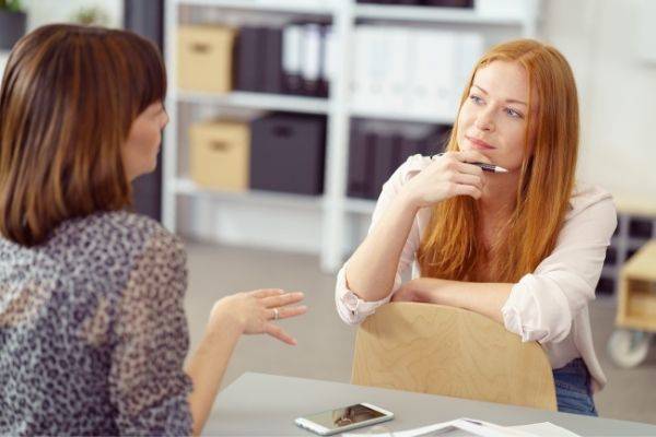 two businesswoman having informal meeting one