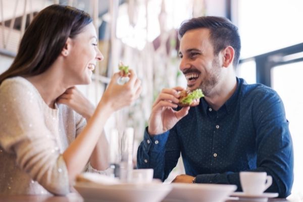 happy loving couple enjoying breakfast cafe smiling food looking at each other