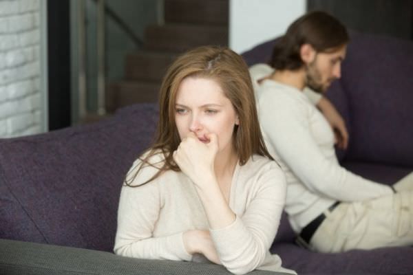 04 sad disappointed wife not talking ignoring her husband sitting on the sofa