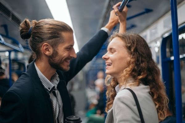 happy couple standing subway train