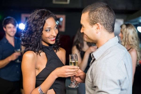 smiling couple drinking champagne nightclub woman and man smiling